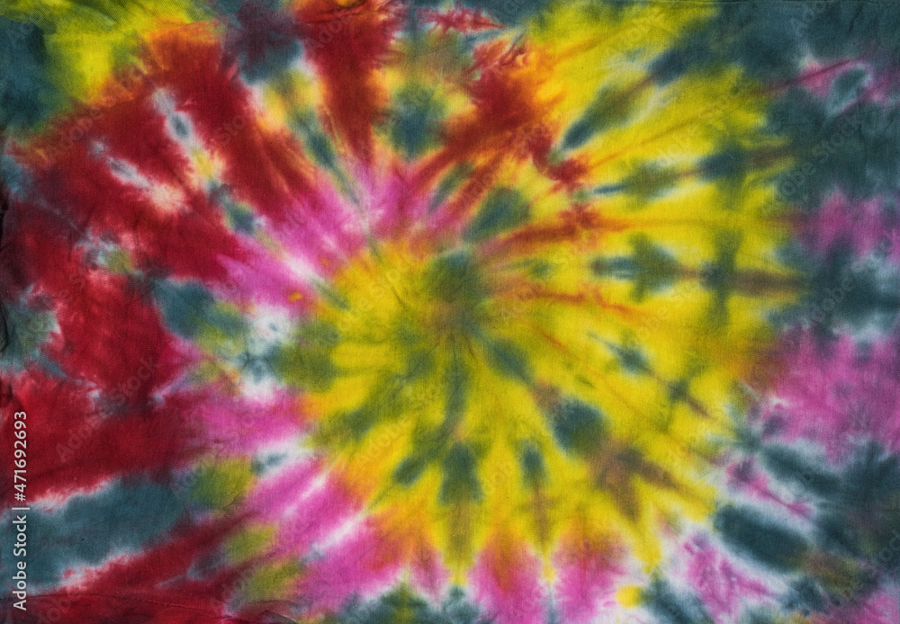 Fototapeta premium Fabric dyed with colorful beautiful tie dye style. Flat lay.