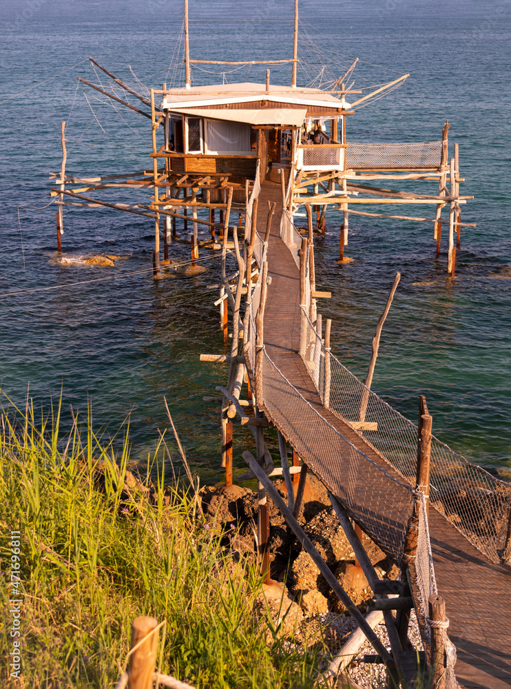 Fototapeta premium A traditional wooden fishing trabocco in the sea in Italy