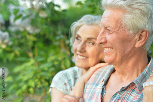 Beautiful senior couple posing in the summer park