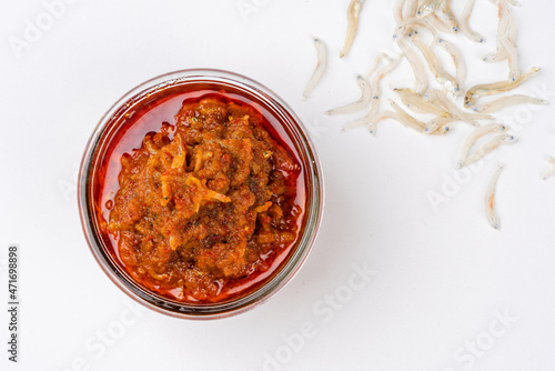 sambal ikan teri or anchovy chili is type of traditional cuisine from Indonesia. Indonesian chili sauce. Sambal ikan teri shoot on White Background. Negative Space.  photo