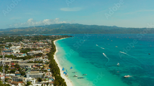 Tropical beach with tourists and clear blue sea, top view. Summer and travel vacation concept. Boracay, Philippines © Alex Traveler