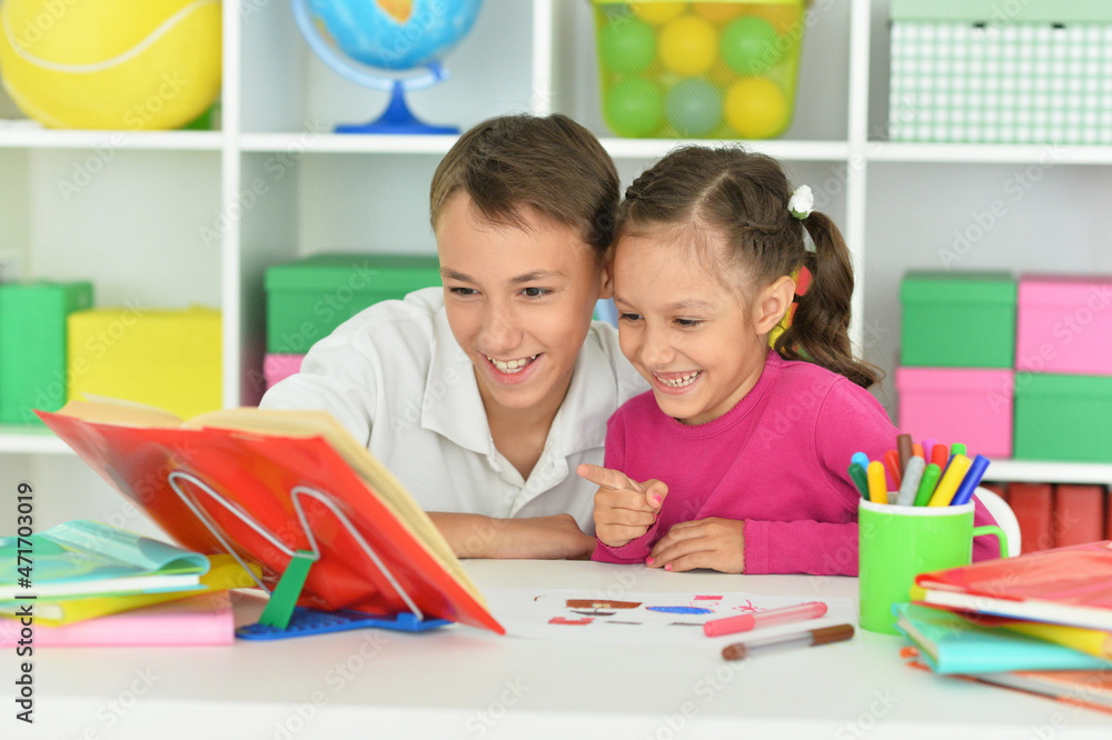 Porait of brother and sister doing homework together Porait of brother and sister doing homework together
