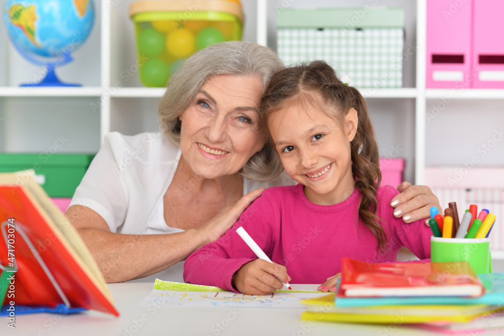 Cute little girl drawing with her grandmother Cute little girl drawing with her grandmother