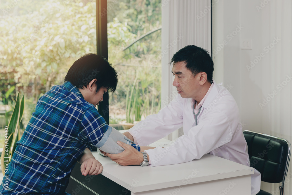 Doctor measuring blood pressure of the patient in the hospital, Medical and health care concepts.