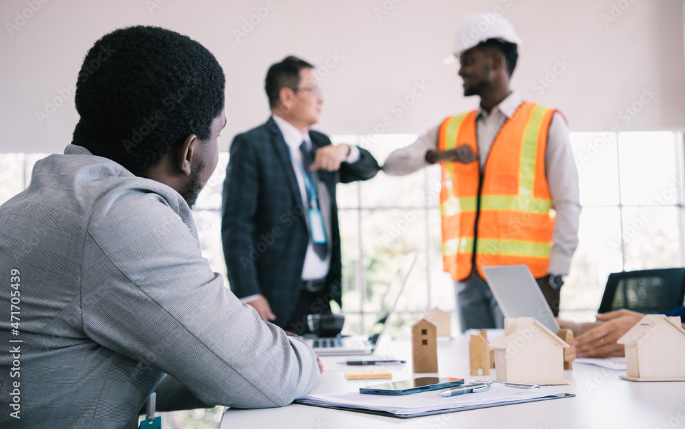 Fototapeta premium Close up, Architect and Business engineer construction workers shaking hands while working for teamwork and cooperation concept after finish an agreement in the office. New normal meeting