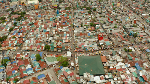Poor district and slums with shacks in a densely populated area of Manila aerial view.