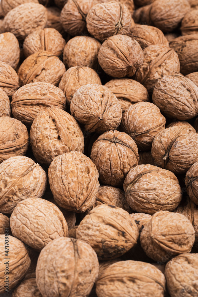 Background from fresh walnuts in the shell. Top view, flat lay. Background from fresh walnuts in the shell. Top view, flat lay.