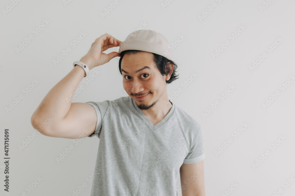 Long hair and beard Asian man in grey t-shirt and cap isolated on white. Long hair and beard Asian man in grey t-shirt and cap isolated on white.