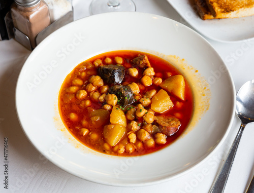 Garbanzos del pastor, spicy soup with chickpea, vegetables and sausages served in a restaurant