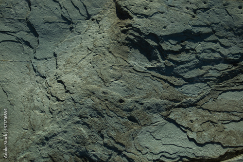 rocky wall of the sea coast in the slanting rays of the sun