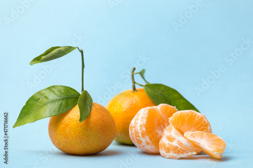 two tangerines and another peeled
