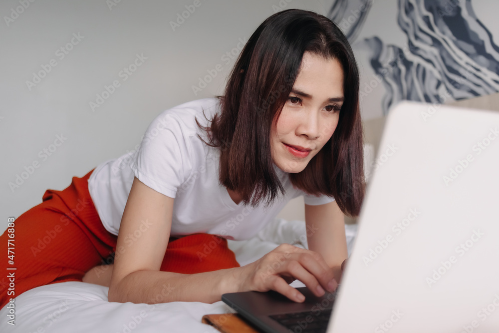 Asian woman is attending a conference in a hotel room. Concept of workation. Asian woman is attending a conference in a hotel room. Concept of workation.
