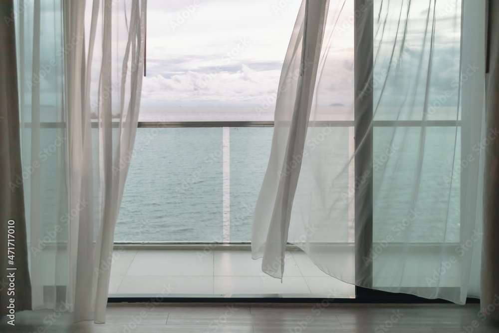 Εκτύπωση καμβά Almost evening time of ocean view from hotel balcony with curtains