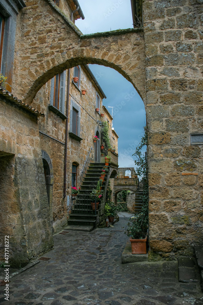 Tuscany, Italy, May 2018, street with stairs and stone arch in the medieval town of Civita