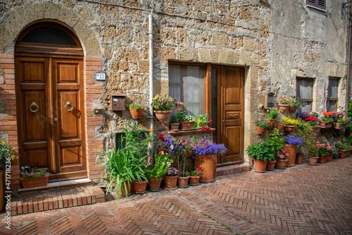 Tuscany, italy, may 2018, street in flowers in the medieval town of Sovana