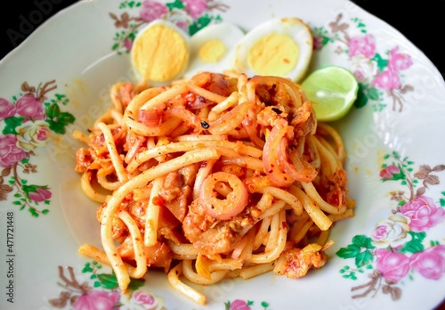 Myanmar traditional thick round noodle salad called Nan Gyi Thohk recipe. Equated as a Burmese version of spaghetti. photo
