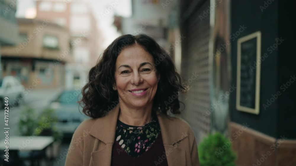 Middle age hispanic woman smiling confident walking at street Middle age hispanic woman smiling confident walking at street