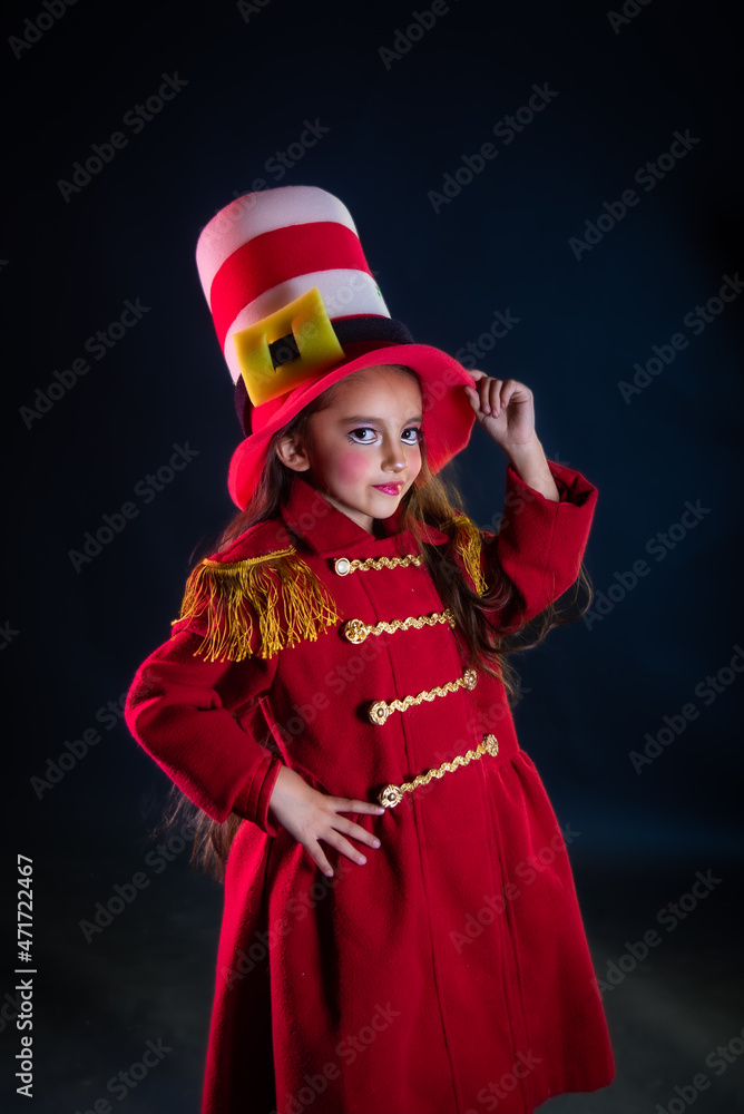 girl dressed as nutcracker with red coat fringes and colorful bokeh lights, hat and theatrical makeup