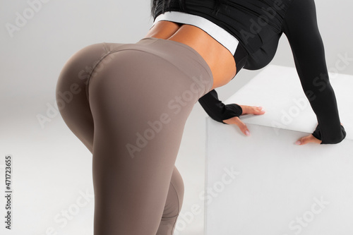 Fitness model in leggings with beautiful buttocks. Sporty booty photo