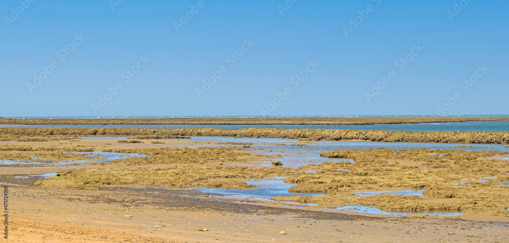 Fishing pens at low tide on the beach of Chipiona, Cadiz, Andalusia, Spain.