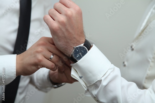 man putting the hand watch on