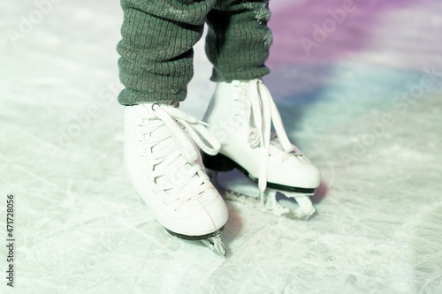 legs in ice skates in close-up, winter entertainment for children
