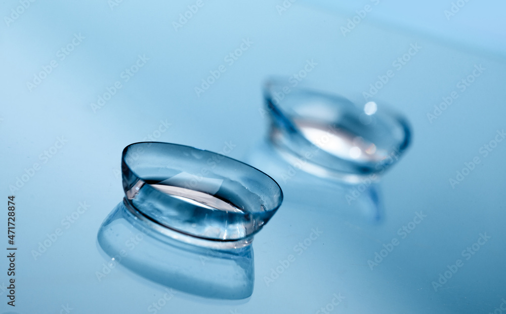 contact lenses on blue background close up view - Image contact lenses on blue background close up view - Image