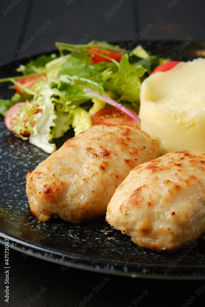 Closeup view of meat cutlet with mashed potato and fresh vegetables