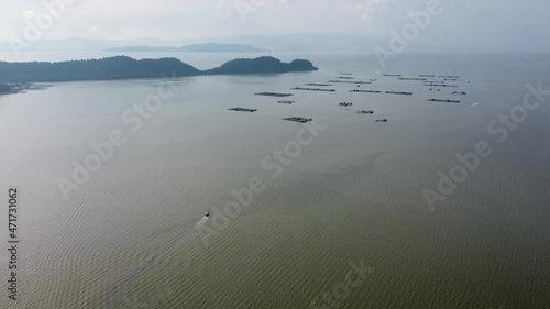 Aerial view a boat move toward kelong near offshore. photo