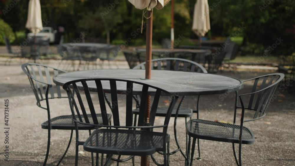 Tables and chairs on the summer area of the restaurant. No visitors at the end of the season Tables and chairs on the summer area of the restaurant. No visitors at the end of the season