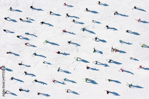 Ski resort. Aerial view of skiers and snowboarders. Winter sports.