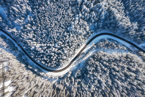 Natural winter landscape from air. Aerial view on the road and forest at the winter time. Winter chill. Forest and snow. The photo is in high resolution. © biletskiyevgeniy.com