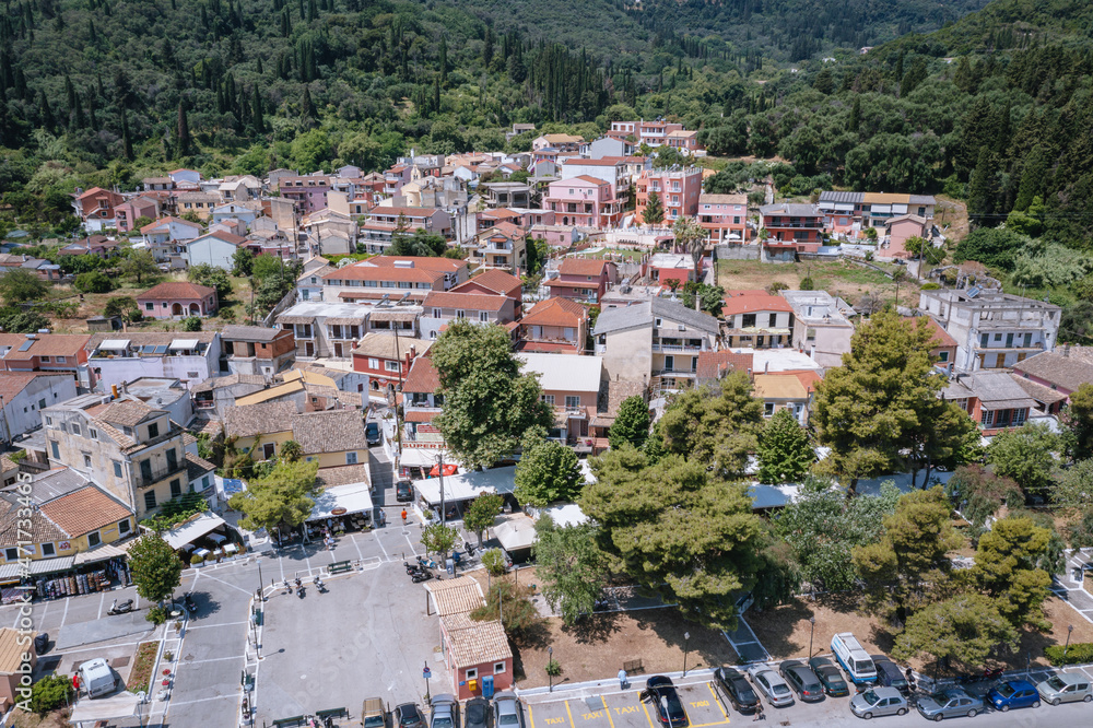 Drone photo of buildings in Benitses town on the Ionian Sea shore on Corfu Island, Greece