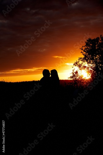 Silhouette of couple in love on sunset background