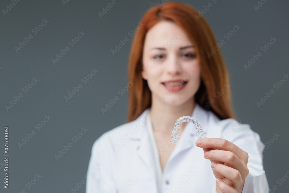 Beautiful smiling Turkish young woman is holding an invisaligner. Beautiful smiling Turkish young woman is holding an invisaligner.