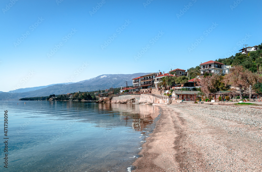 Abovos beach in Afissos, a traditional fishing village built amphitheatrically on the slopes of Mount Pelion, with view to the Pagasetic Gulf. Wintertime, empty beach. In Thessaly, Greece.