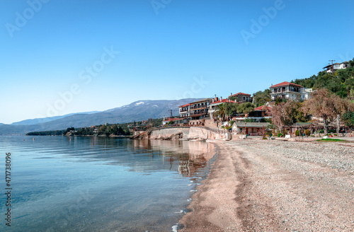 Fototapeta Naklejka Na Ścianę i Meble -  Abovos beach in Afissos, a traditional fishing village built amphitheatrically on the slopes of Mount Pelion, with view to the Pagasetic Gulf. Wintertime, empty beach. In Thessaly, Greece.