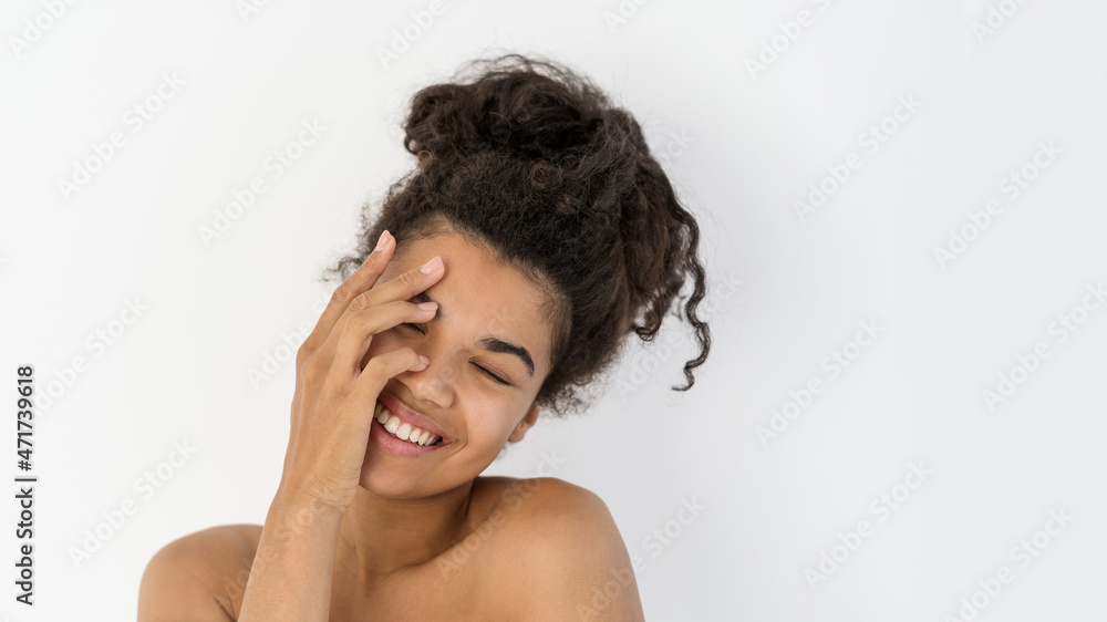 Young afro american woman laughing, cover face with hand Young afro american woman laughing, cover face with hand