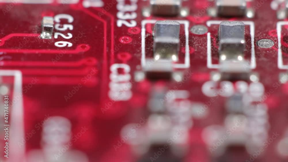 Close up video of an old red computer complex motherboard with chips, transistors, resistors and semiconductors Close up video of an old red computer complex motherboard with chips, transistors, resistors and semiconductors