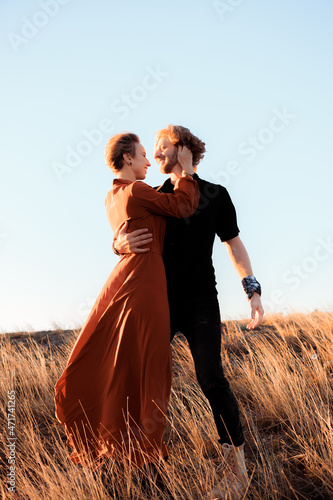 .happy and loving couple in the setting sun- Image