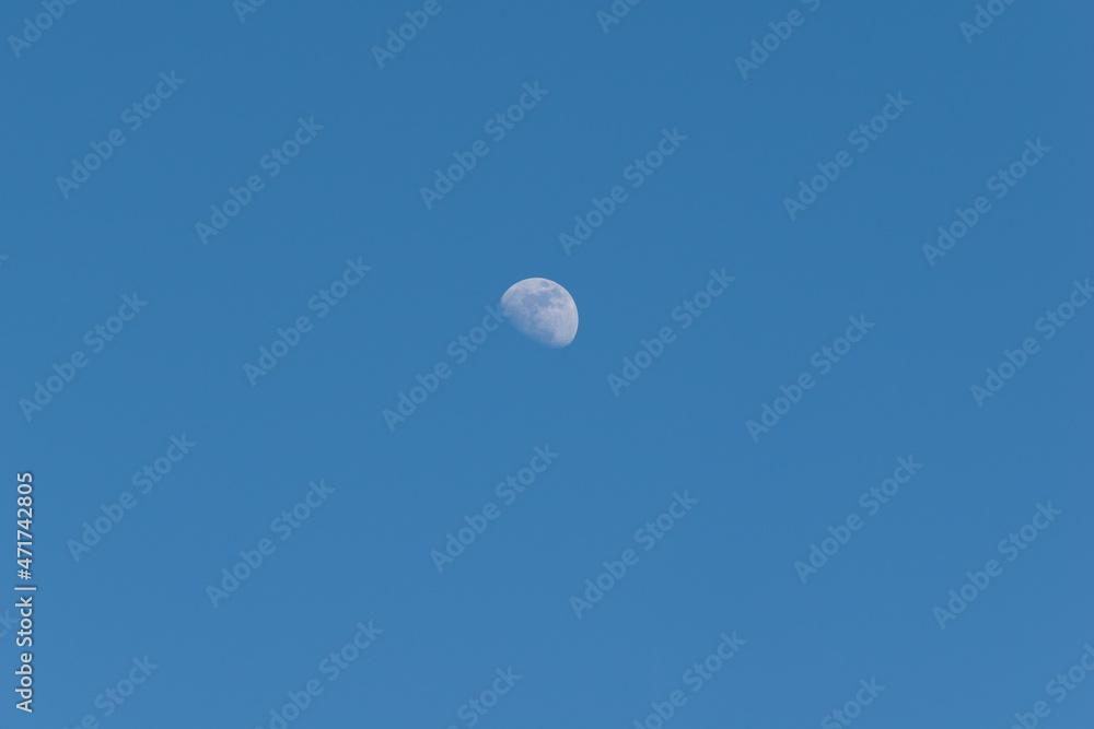 Crescent moon on a blue sky day in Madrid, Spain Crescent moon on a blue sky day in Madrid, Spain