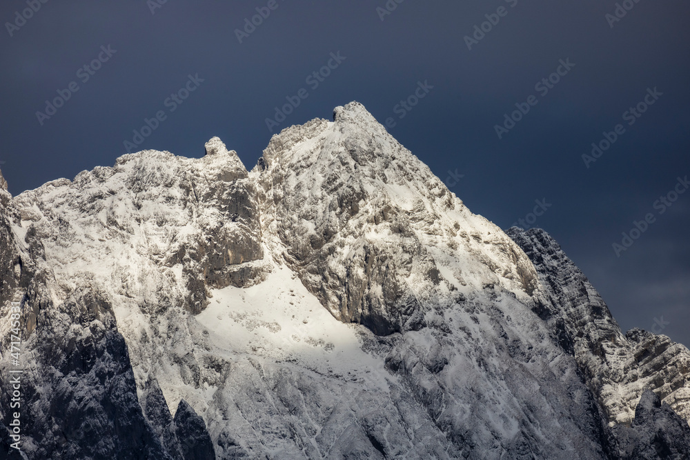 snow covered mountain with dark sky