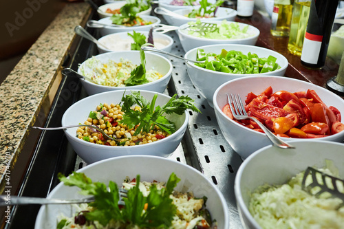 Restaurant with fresh and organic salads. Self-service food in a mall. Salad meals on counter top at buffet catering service 