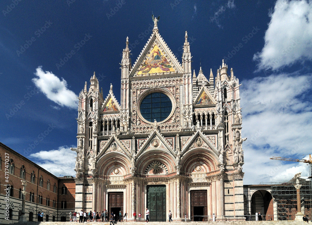 Facade Of The Famous Cathedral Of Siena Tuscany Italy On A Beautiful Spring Day With A Blue Sky And A Few Clouds