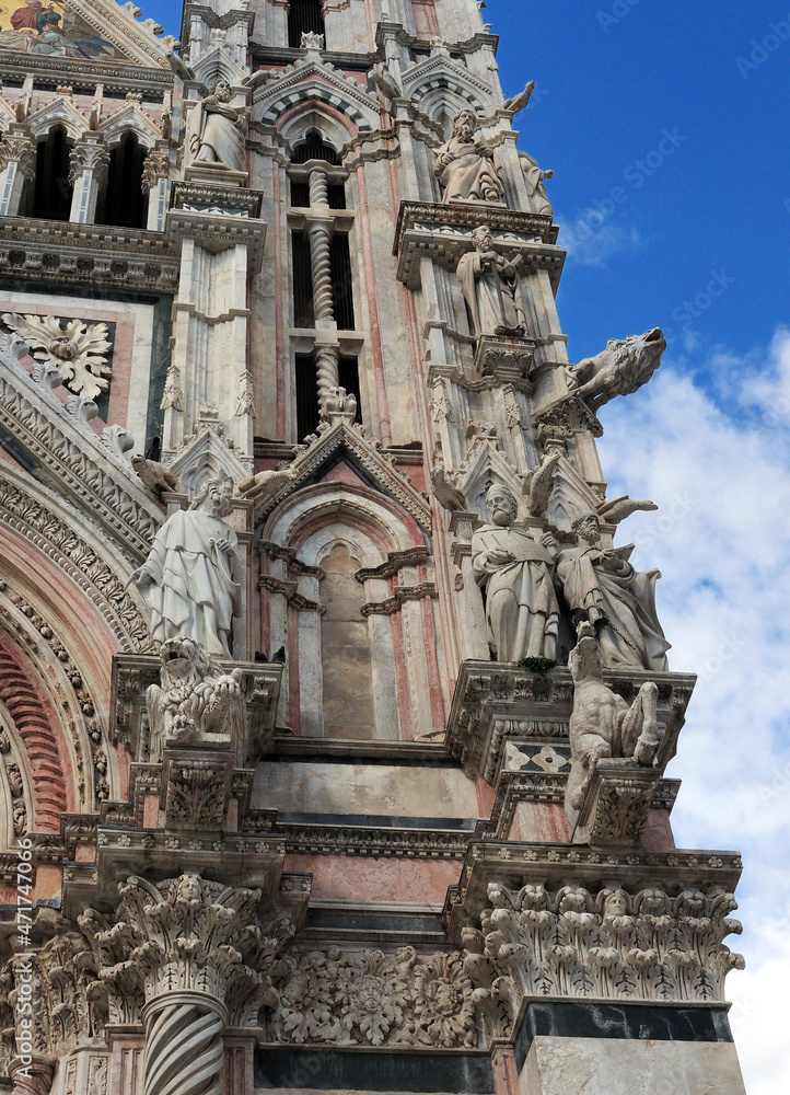 Close Up Of The Facade Of The Famous Cathedral Of Siena Tuscany Italy On A Beautiful Spring Day With A Blue Sky And A Few Clouds