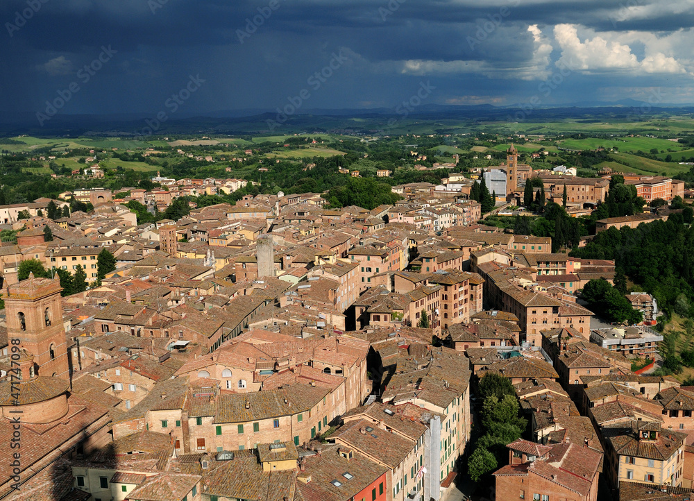 View From The Tower Torre Del Mangia To The Old Town Of Siena Tuscany Italy On A Beautiful Spring Day With Dark Thunderstorm Clouds In The Sky