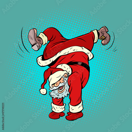 Santa Claus dancing, handstand. Christmas and New Year. Winter seasonal holiday