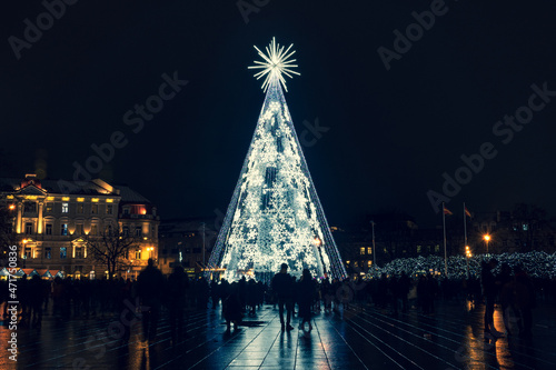 Beautiful white Christmas tree with snowflakes in Vilnius Cathedral square, Lithuania, Europe, no market and events due to Covid or Coronavirus pandemic