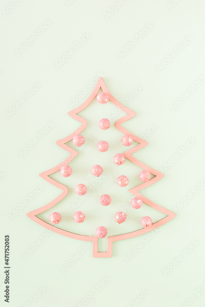Pastel pink Christmas tree with pink baubles on a pastel green background. New Year aesthetic concept Pastel pink Christmas tree with pink baubles on a pastel green background. New Year aesthetic concept