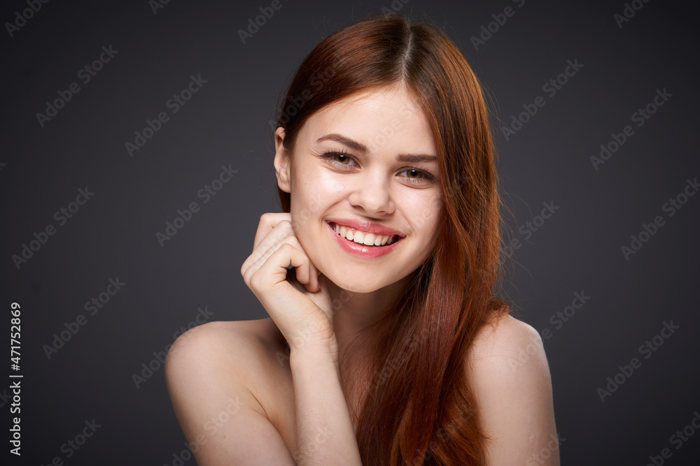 pretty red-haired woman naked shoulders posing dark background pretty red-haired woman naked shoulders posing dark background